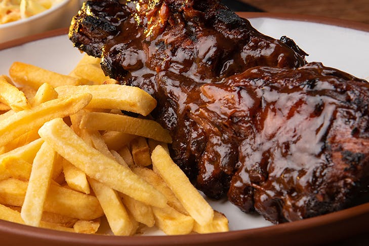 a close up of ribs and chips